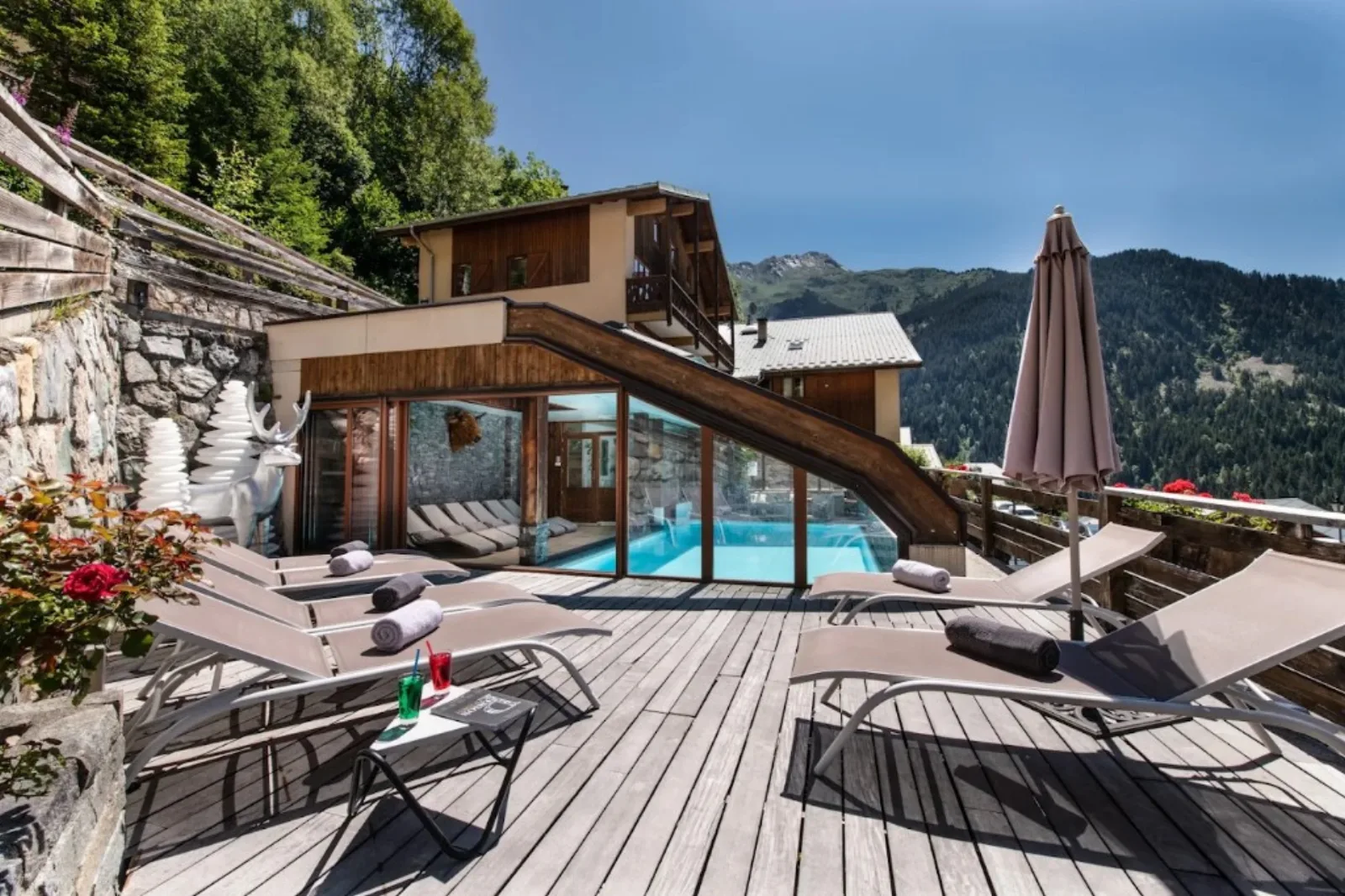 Résidence Club Alpina terrace and covered pool with alpine slopes above Champagny-en-Vanoise